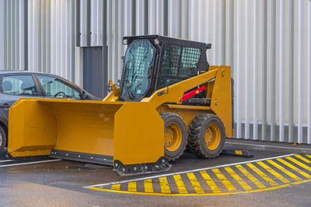 Skid Steer Strait Snow Pusher Machine Attachment at Parking Lotの写真素材