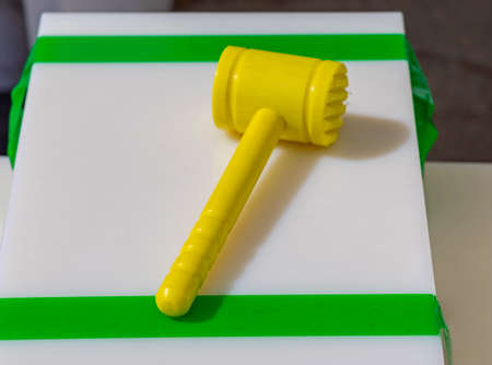 Yellow Hammer Mallet at Plastic Cutting Board Kitchen Equipmentの写真素材
