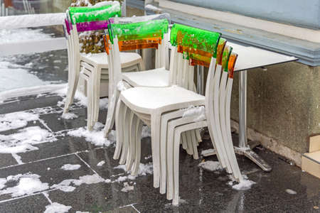 White Plastic Chairs and Table Covered With Snow Winter Weatherの写真素材