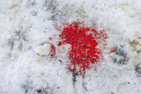 Red Paint in Snow at Cold Winter Streetの写真素材