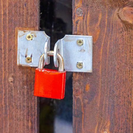 Red Padlock at Wooden Shed Window Blindsの写真素材