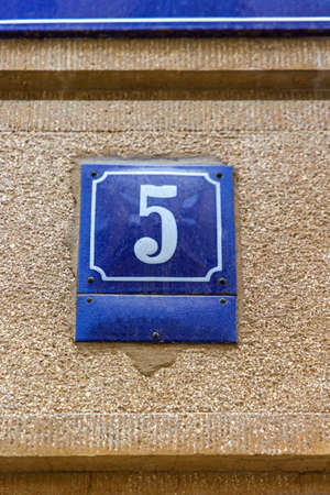 Blue Enamel Number Five Sign at House Wallの写真素材