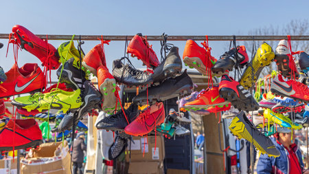 Belgrade, Serbia - March 26, 2022: Colourful Cleats Soccer Football Sports Shoes Hanging by Laces at Flea Market.のeditorial素材