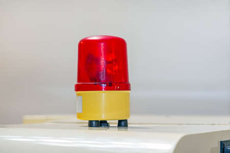 Red Dome Warning Rotating Light at Top of Machine