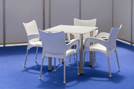 Plastic Table With Chairs at Blue Carpet in Expo Boothの写真素材