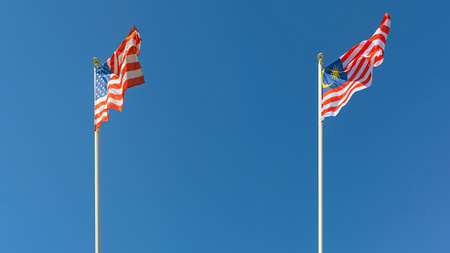 United States of America and Malaysia Flags Together at Sunny Day Blue Sky