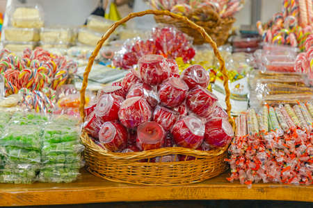 Red Candy Apples in Basket at Fun Fairの写真素材