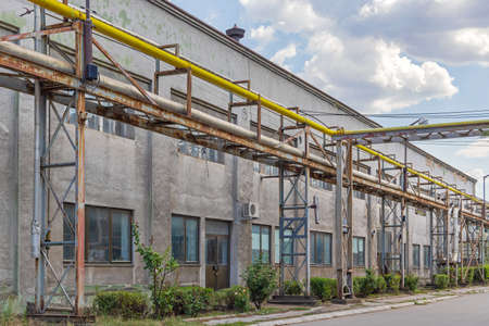 Yellow Gas Pipe and Silver Heating Pipeline at Rust Industry Factoryの写真素材