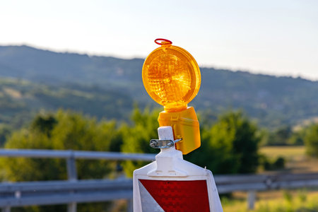 Flashing Amber Light Beacon at Traffic Panel Highway Roadworks