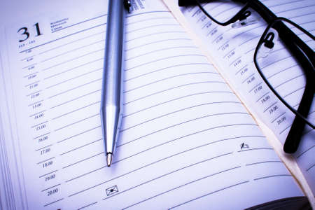 Address book, pen   black glassesの写真素材