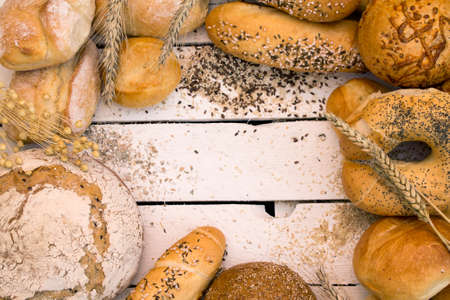 Different types of bread on white wooden boardの写真素材