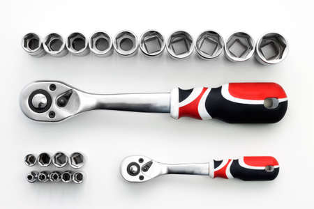 Ratchet socket on white background. Combination of red, black and white color