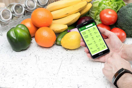 Counting calories in smartphone. Concept of app for healthcareの写真素材