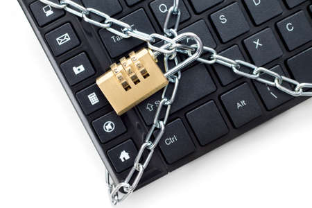 Locked chain on computer keyboard. Concept of securityの写真素材