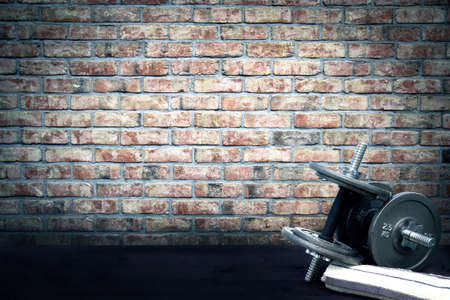 Dumbbells and towel lying on the ground in vintage stylization. Empty space for your text.の写真素材