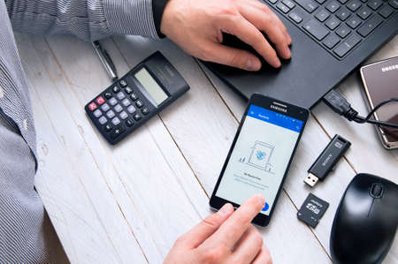 WROCLAW, POLAND- OCTOBER 05th, 2016:  Man launches Dropbox application on Samsung A5. Dropbox is a...