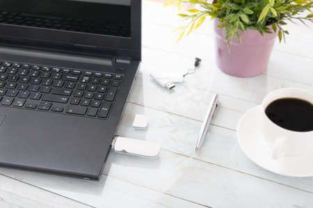 White GSM modem plugged in a laptop