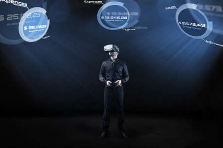 Businessman checks account balance in virtual reality. Conception of VR technology in office work