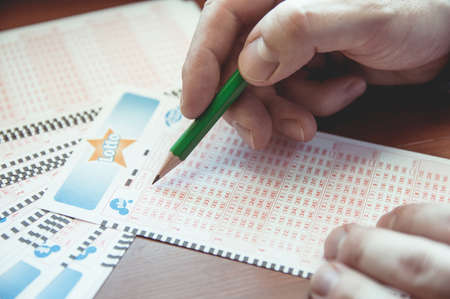 WROCLAW, POLAND -  MARCH 28th, 2017: Man fill out a lotto lottery ticket. Lottery organized by Totalizator Sportowy. It has been in Poland since 1957.のeditorial素材