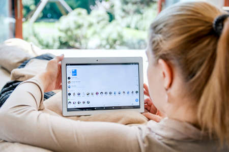 WROCLAW, POLAND- APRIL 10th, 2017:  Woman launches messenger application on Lenovo tablet. Messenger  is an instant messaging service and software applicationのeditorial素材