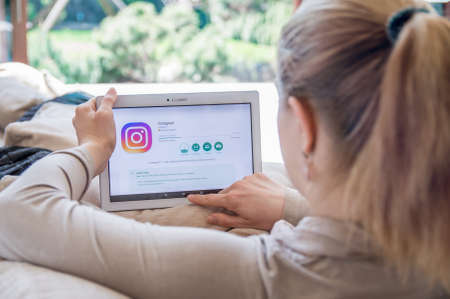 WROCLAW, POLAND- APRIL 10th, 2017:  Woman is installing Instagram application on Lenovo tablet. Instagram is a mobile photo-sharing application and service that allows users to share picturesのeditorial素材