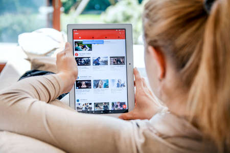 WROCLAW, POLAND- APRIL 10th, 2017:  Woman launches Youtube application on Lenovo tablet. YouTube is an American video-sharing website headquartered in San Bruno, California.のeditorial素材