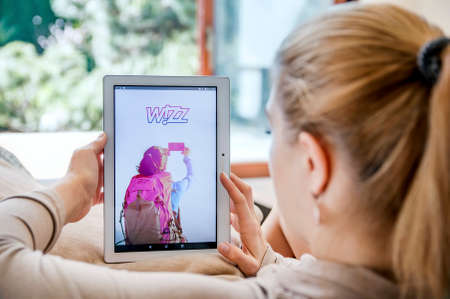WROCLAW, POLAND- APRIL 10th, 2017:  Woman launches Wizz application on Lenovo tablet. Wizz Air Hungary Ltd.  is a Hungarian low-cost airline with its head office in Budapest.のeditorial素材