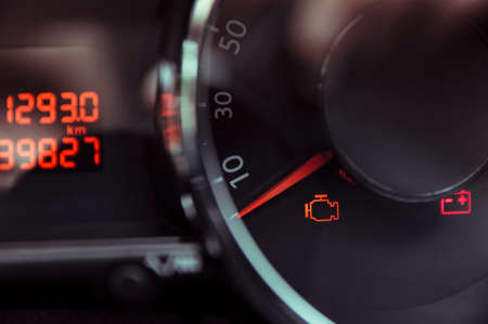 Check engine light. Car dashboard in closeupの写真素材