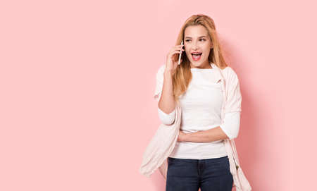 Young woman is smiling while talking by her smartphone
