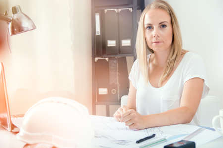 Architect is working with her new project at home officeの写真素材