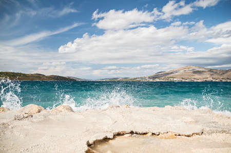 Sea waves hitting the rocky shore somewhere over adriaticの写真素材