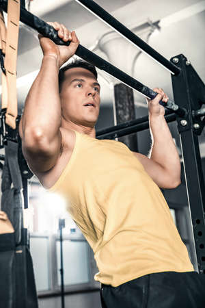 Man performs lifting excercise at the gym