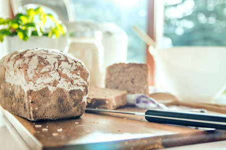 Close-up of home baked bread on modern kitchen countertop. Photo taken in the light of natural sun...