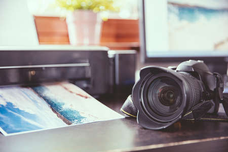Desk with a DSLR camera and wirelles printer