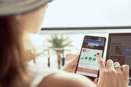 TROGIR, CROATIA  -  SEPTEMBER 13th, 2018: Woman is installing Airbnb application on Nokia smartphone. Airbnb is an online marketplace and hospitality service, enabling people to lease or rent short-term lodgingのeditorial素材