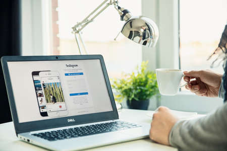 WROCLAW, POLAND - NOVEMBER 29th, 2018: Modern laptop on the desk in office with Instagram website on the screen. Instagram is a photo and video-sharing social networking service owned by Facebook, Inc.のeditorial素材