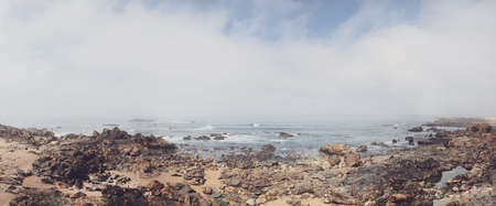 Rocky shore with a cloudy view over atlantic sea in portugal