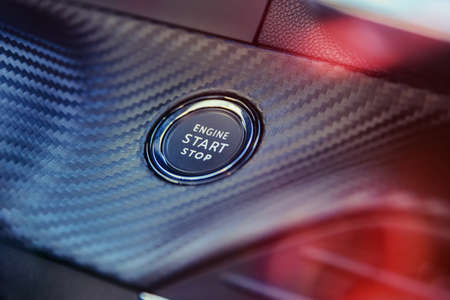 Engine start stop button in modern sport car.