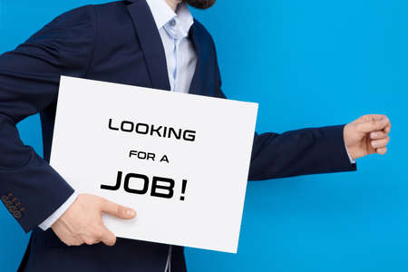 Businessman on the run with white board with "looking for a job" sign. Business conception of searching for a job.の写真素材