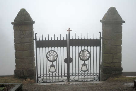 Small Cemetery Gate with fog as a backgroundの写真素材