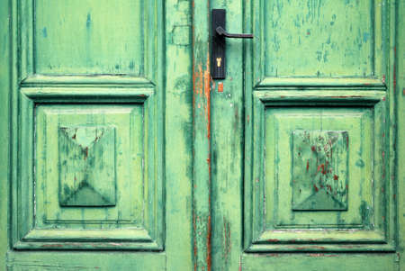 Old flaked classic green door and door handleの写真素材