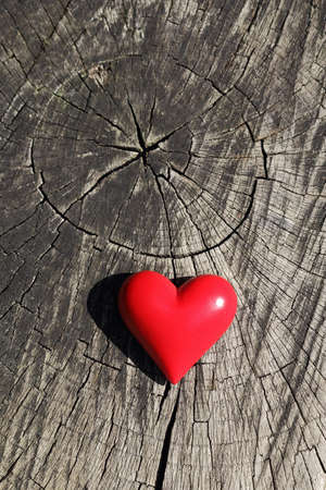 Small red heart on a wooden backgroundの写真素材