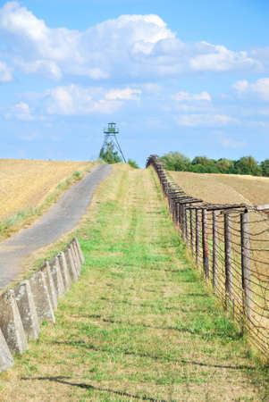 Iron curtain and watchtower with patrol road in former Czechoslovakiaの写真素材