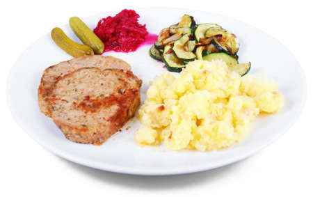 Plate of freshly cooked meat loaf with mashed potatoes and vegetable garnishの写真素材