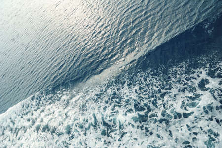 Abstract sea background with a wave and foam
