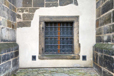 Window with bars set in an old fortress stone wall