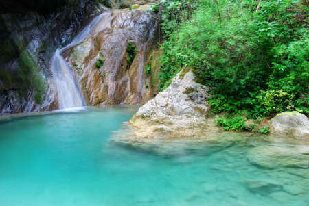 Natural pool with azure water and a small waterfallの写真素材