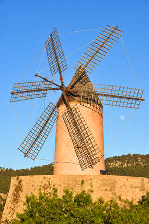 Old traditional windmill under a blue skyの写真素材