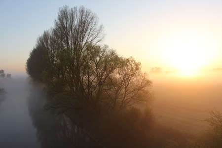 Mist over the river at sunriseの写真素材