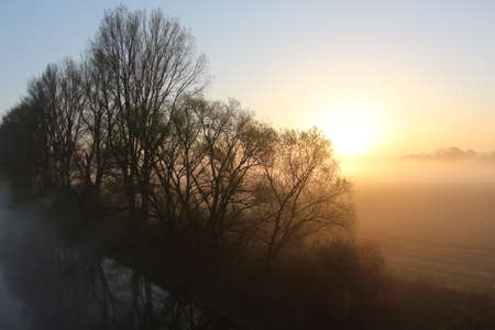 Mist over the river at sunriseの写真素材